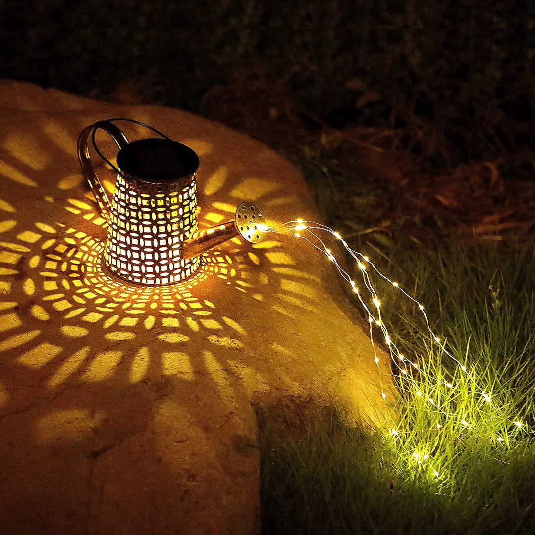 Decorative solar watering can with warm fairy lights, illuminates garden paths and outdoor spaces.