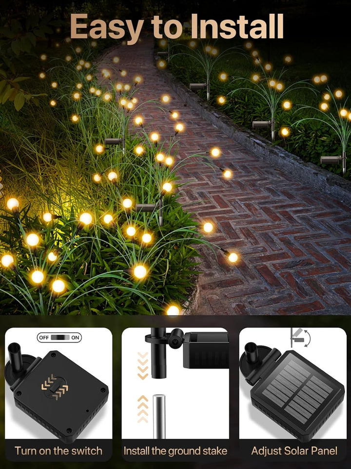 Energy-efficient solar firefly lights with leaf design, casting a warm glow on a garden landscape