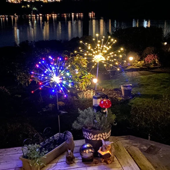 Waterproof solar firework lights reflecting on a wet surface in a garden, durable outdoor decor.