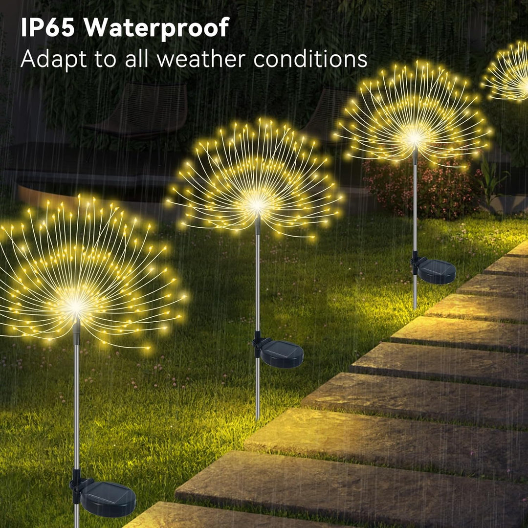 Outdoor garden scene with illuminated solar firework lights, ideal for patio and lawn decoration.