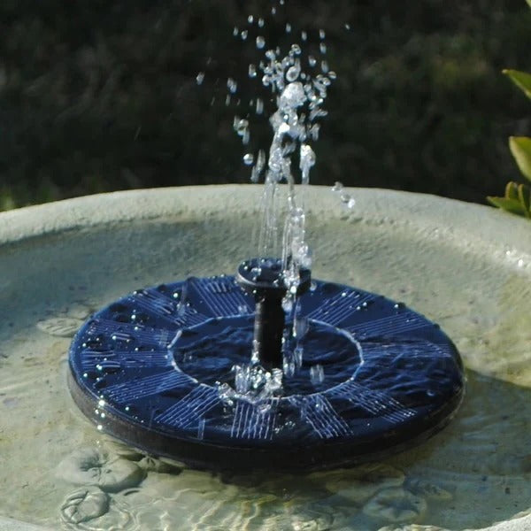 Close-up of a solar powered water feature, a floating fountain pump for ponds and bird baths.