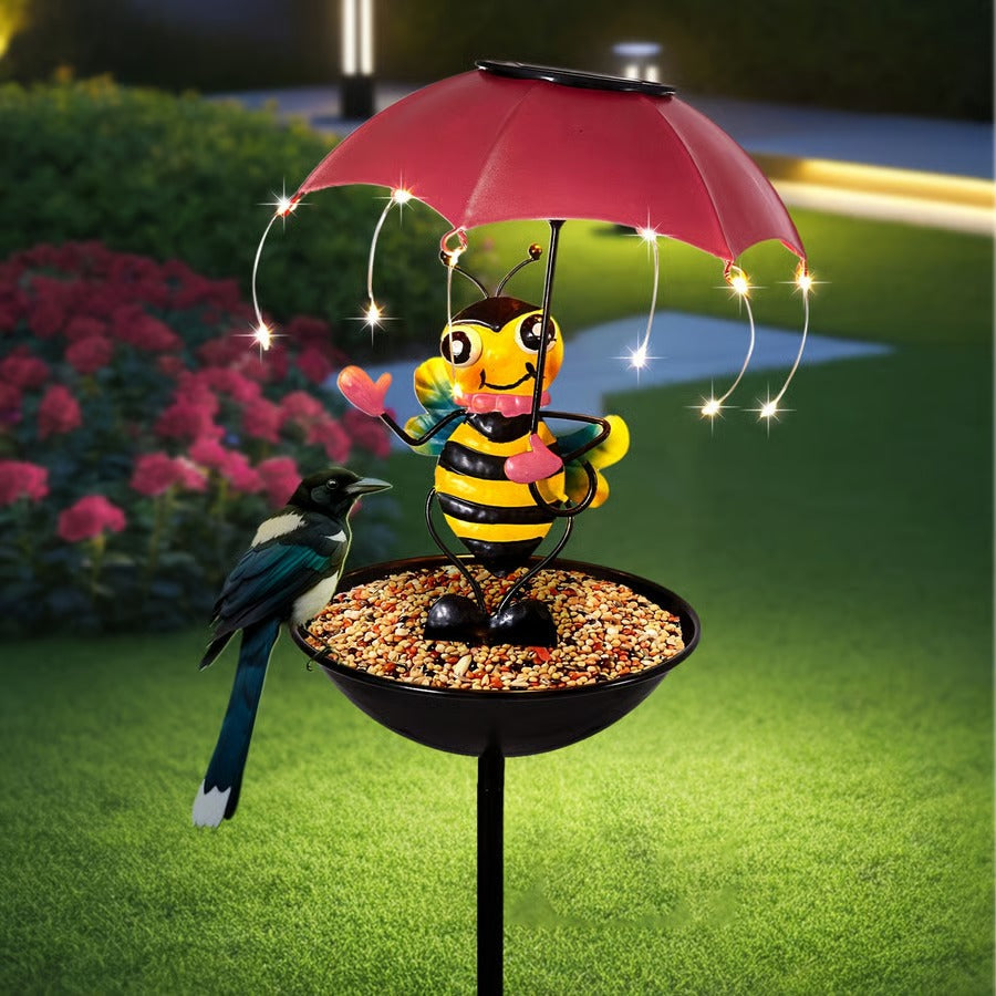 Close-up of solar LED bird feeder with ornate animal garden stake, perfect for garden decor