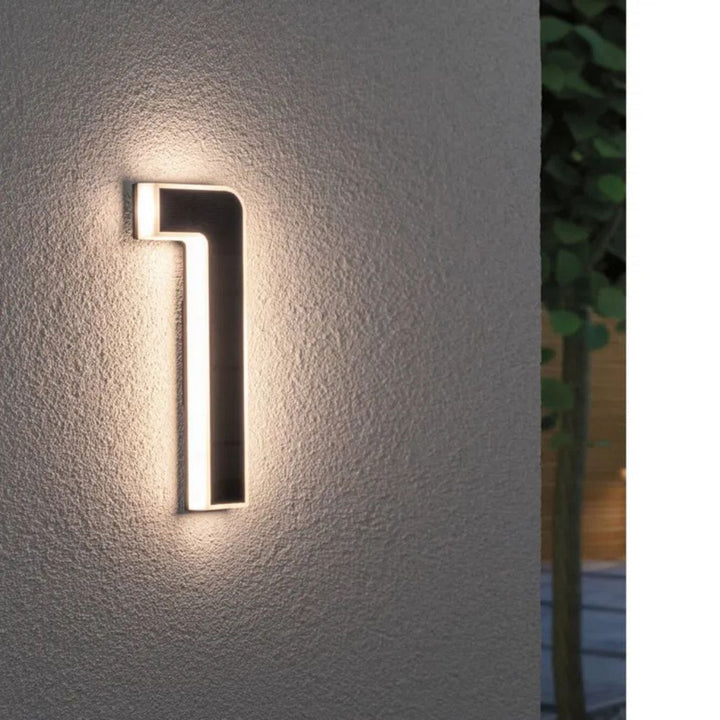 Illuminated address plaque with solar power, weather resistant for enhanced exterior visibility.