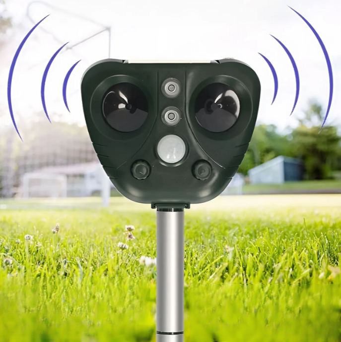 Solar ultrasonic bird repeller mounted in a garden, protecting plants from pests with humane outdoor deterrent.