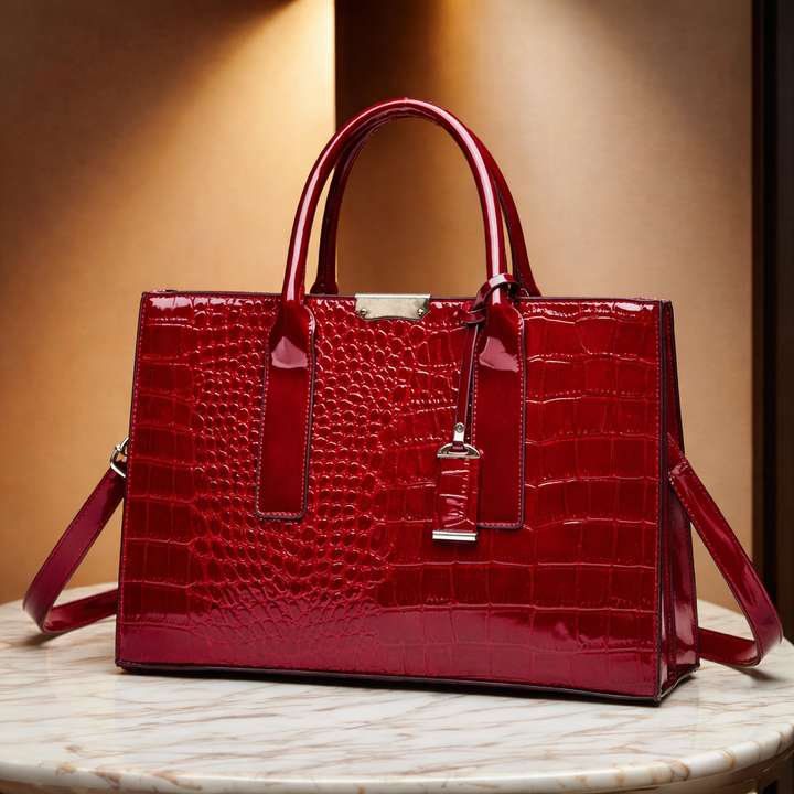 Burgundy Madison croc-embossed structured handbag for women. Elegant multi-pocket vegan leather fashion accessory.