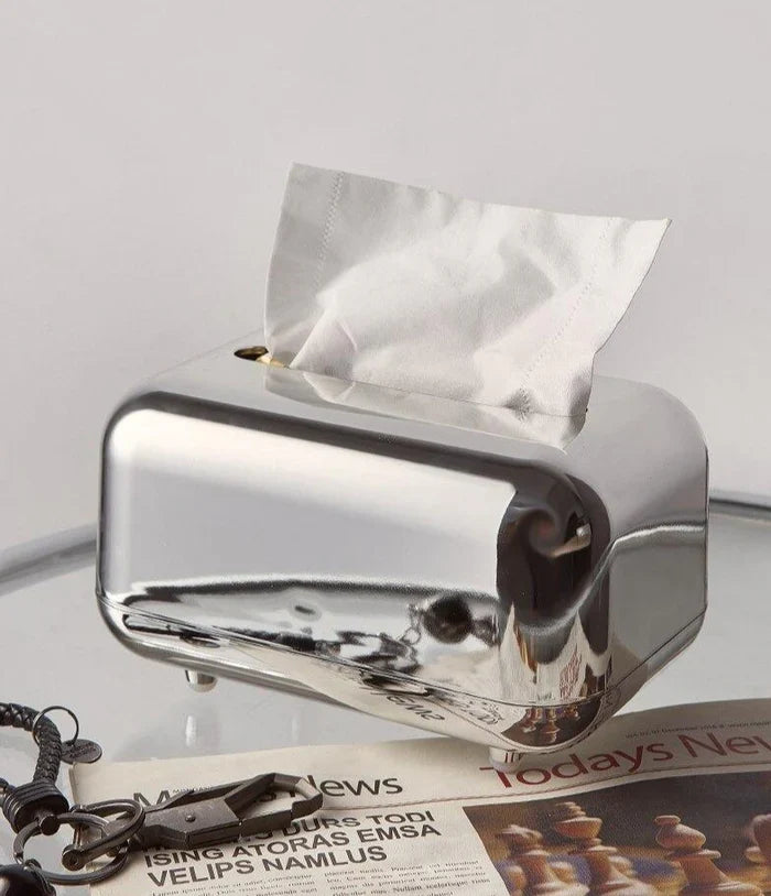 Detailed gold & silver modern tissue dispenser, a chic home decor piece.