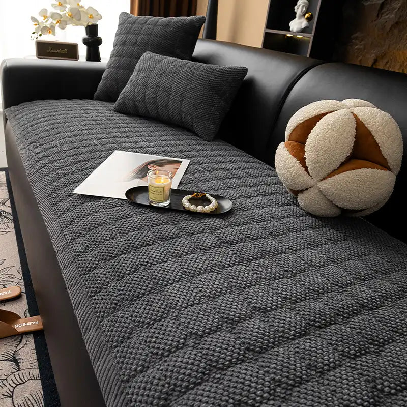 Tan square corduroy couch cover, non-slip and scratch-resistant for pet owners, on a sofa.