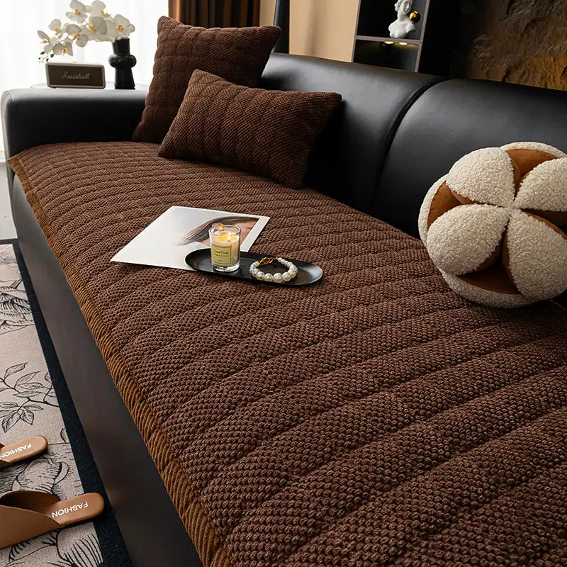 Machine washable square corduroy couch cover, pet-friendly and non-slip, draped over furniture.