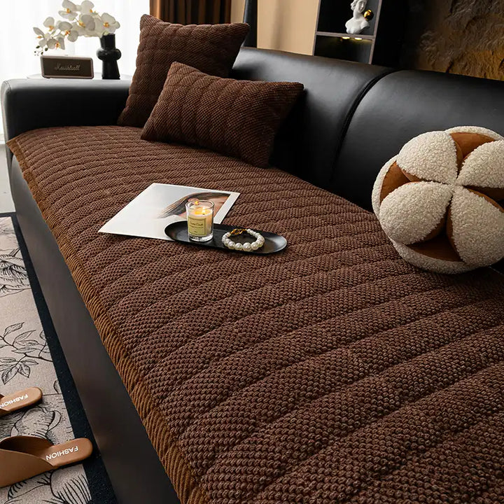 Machine washable square corduroy couch cover, pet-friendly and non-slip, draped over furniture.