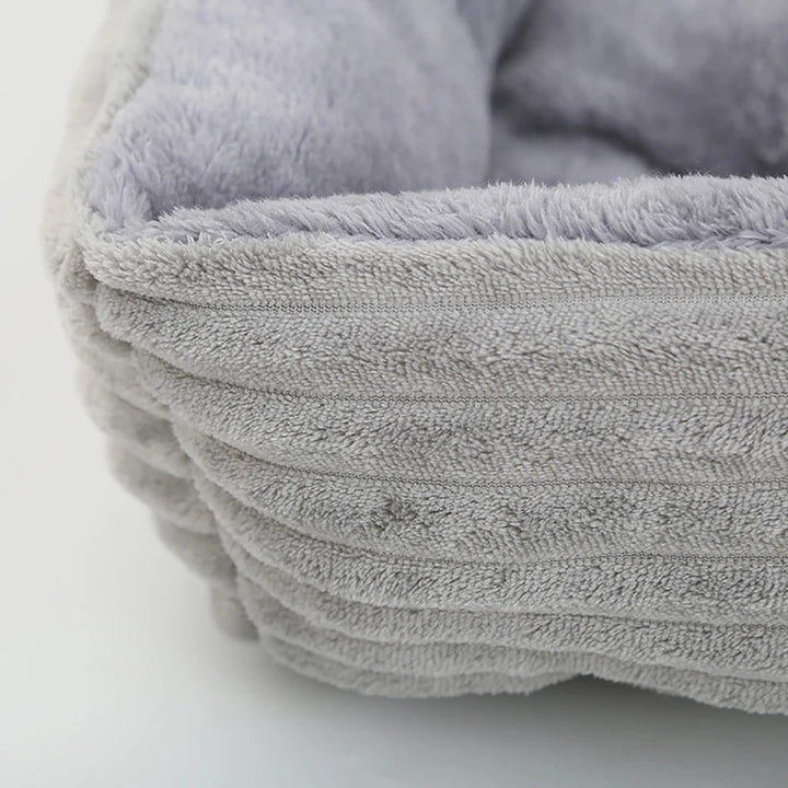 Calming pet bed, square design, featuring plush interior and a robust waterproof oxford base