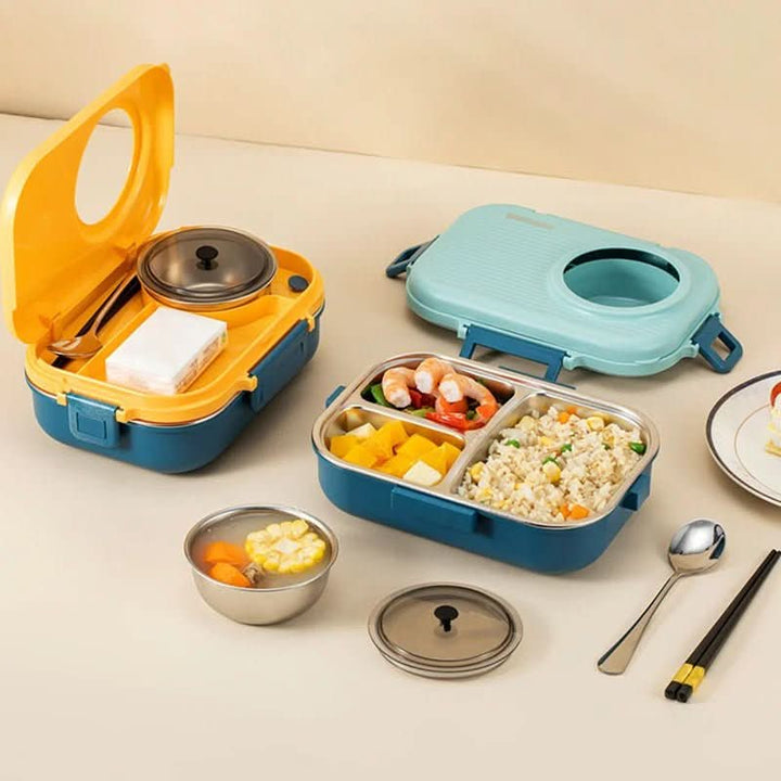 Stainless steel 3-compartment lunchbox filled with colorful healthy food for a portable work lunch.