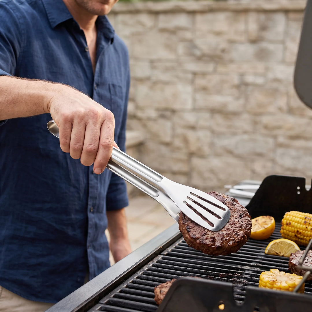 Stainless steel slotted kitchen tongs for cooking, grilling, and serving food.
