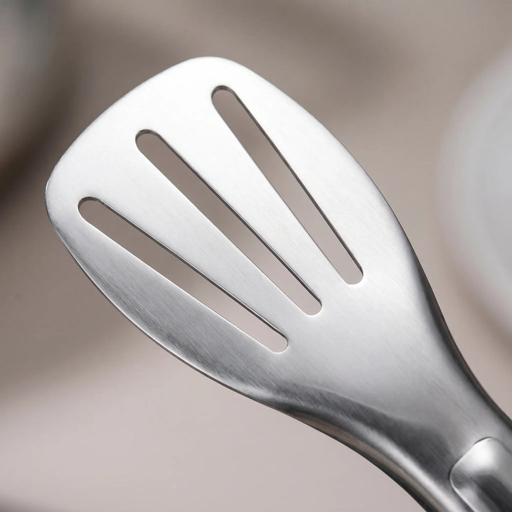 Durable stainless steel slotted kitchen tongs, perfect for draining while serving.