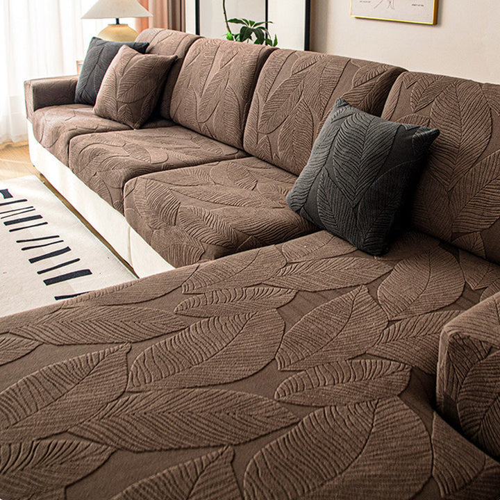 Stretch universal sofa cover with elegant leaf jacquard design, pet-friendly furniture protector.