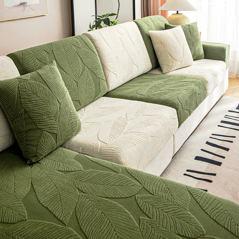 Beige stretch sofa slipcover featuring a subtle leaf pattern, perfect for pet protection and home decor.