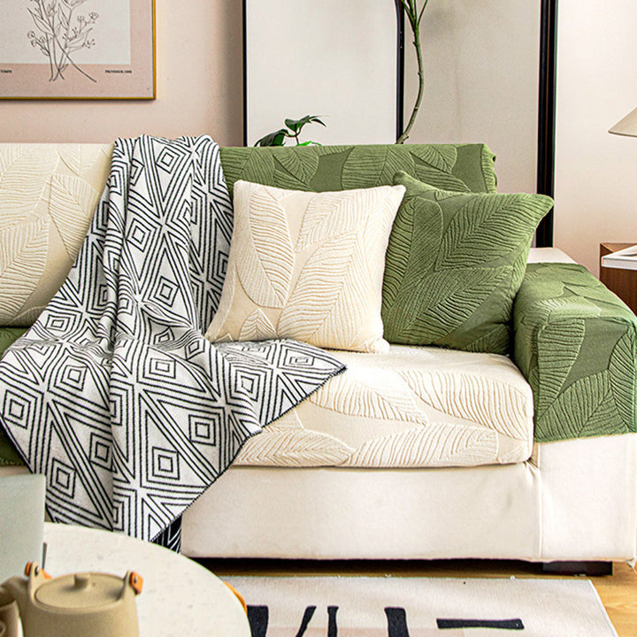 Waterproof sofa cover in a modern leaf design, offering pet protection and easy care.