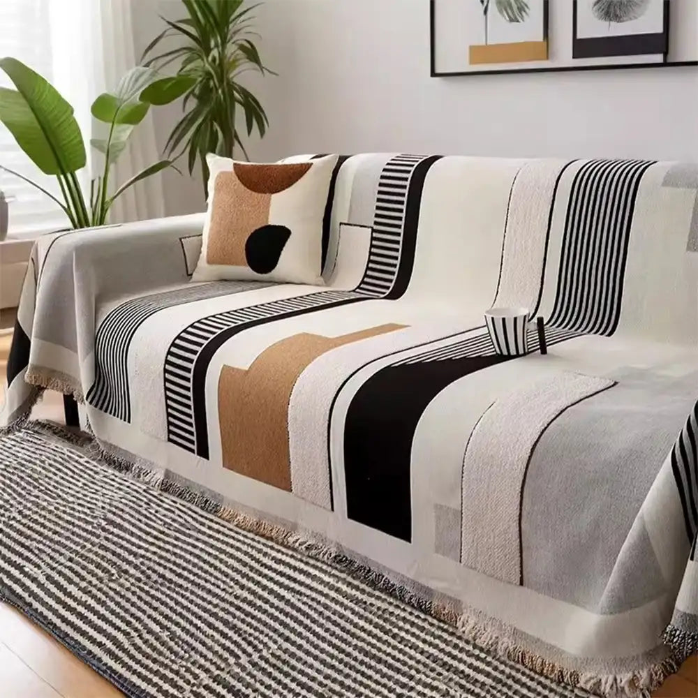 Multi-functional stripe chenille sofa protector draped over a living room couch.