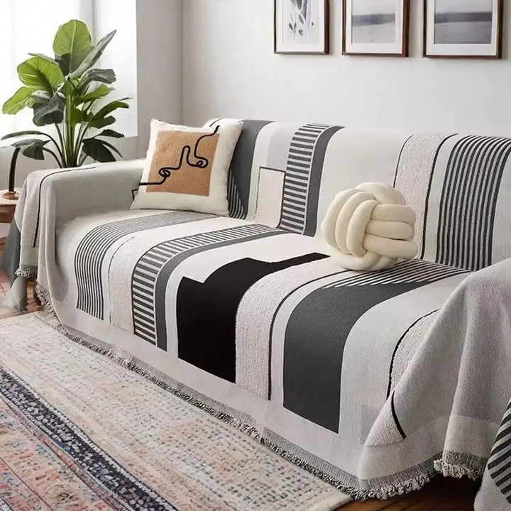 Full view of a couch covered with a stripe chenille sofa protector, enhancing home decor.