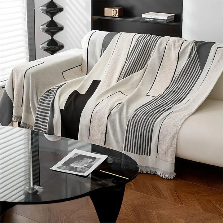 Living room with a sofa neatly covered by a multi-functional stripe chenille protector.
