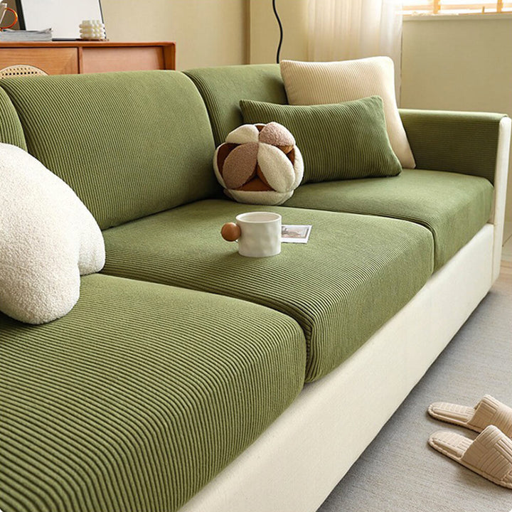 Stretched stripe corduroy couch cover over sofa armrest, showing snug fit and anti-scratch features