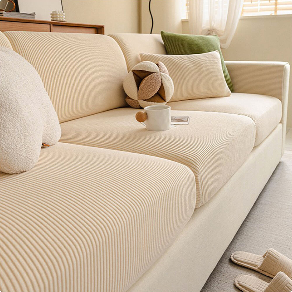Stripe corduroy full coverage couch protector on a section of a large sofa, pet proof design