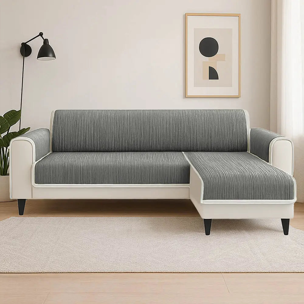 Striped pet sofa slipcover with elastic straps for a snug fit, ensuring furniture protection from pets.