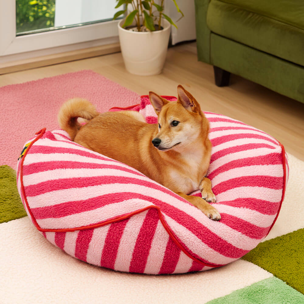 Striped polygonal calming dog bed in faux lambswool, modern pet furniture for dog comfort.