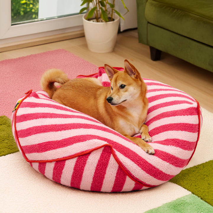 Striped polygonal calming dog bed in faux lambswool, modern pet furniture for dog comfort.