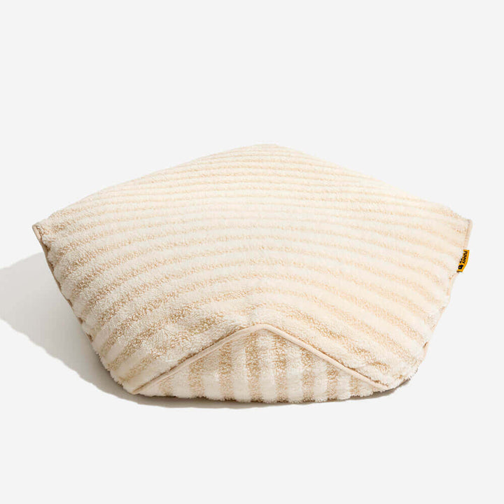 Cozy striped polygonal dog bed, faux lambswool, provides a calming retreat for pets.