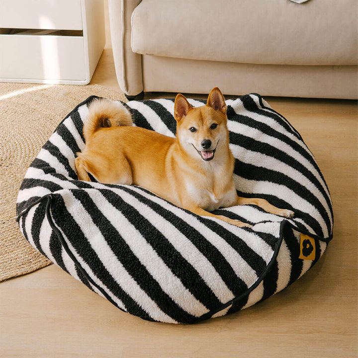 Striped polygonal dog bed, deep orthopedic support, calming pet furniture for rest.