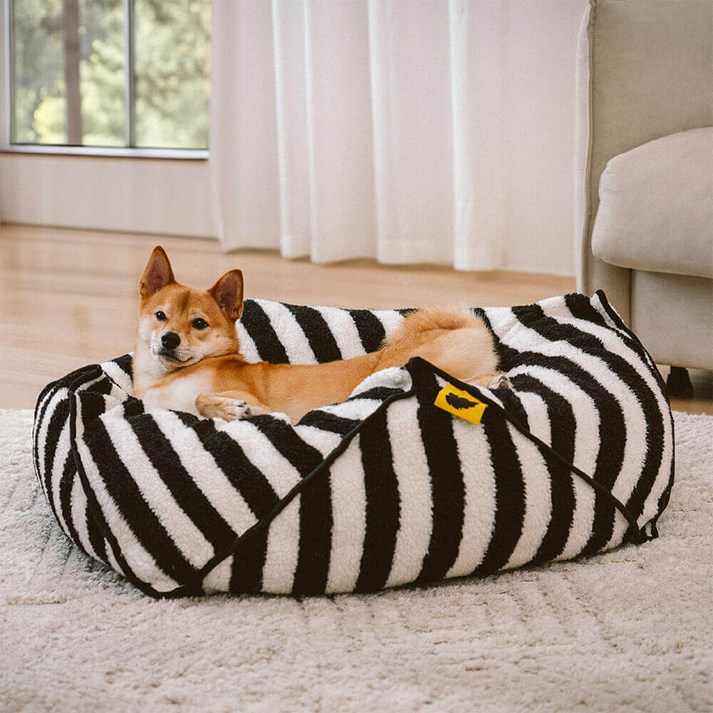 Warm faux lambswool striped dog bed, geometric shape, ideal calming pet supplies.