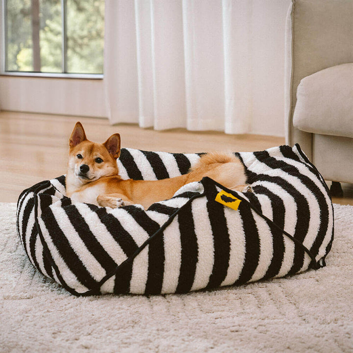 Warm faux lambswool striped dog bed, geometric shape, ideal calming pet supplies.