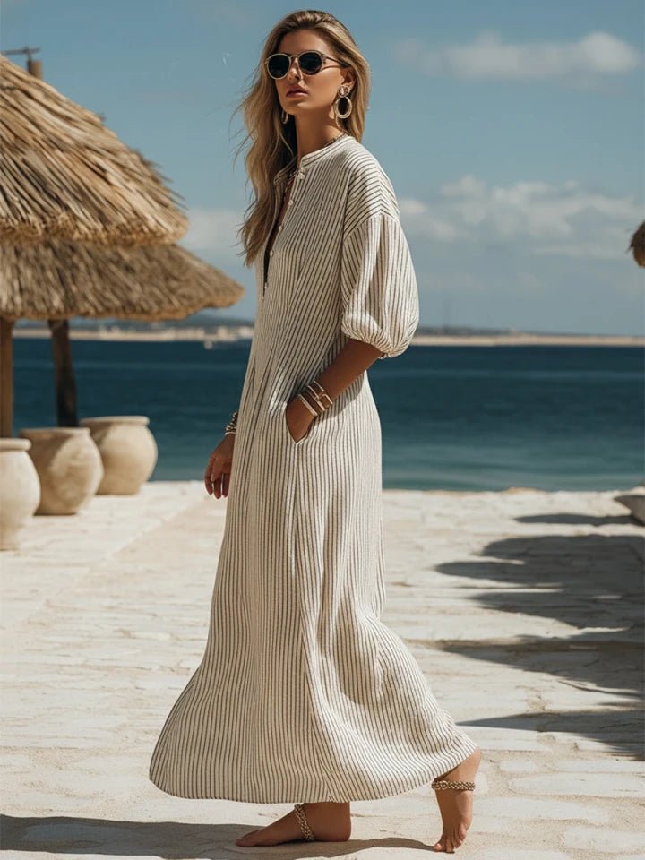 Chic striped maxi dress, V-neck, puff sleeves, and side split detail. Perfect women's summer fashion.