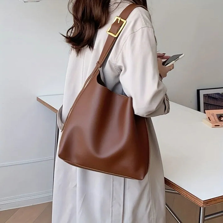Elegant black women's everyday shoulder bag, a classic accessory for modern versatile style.