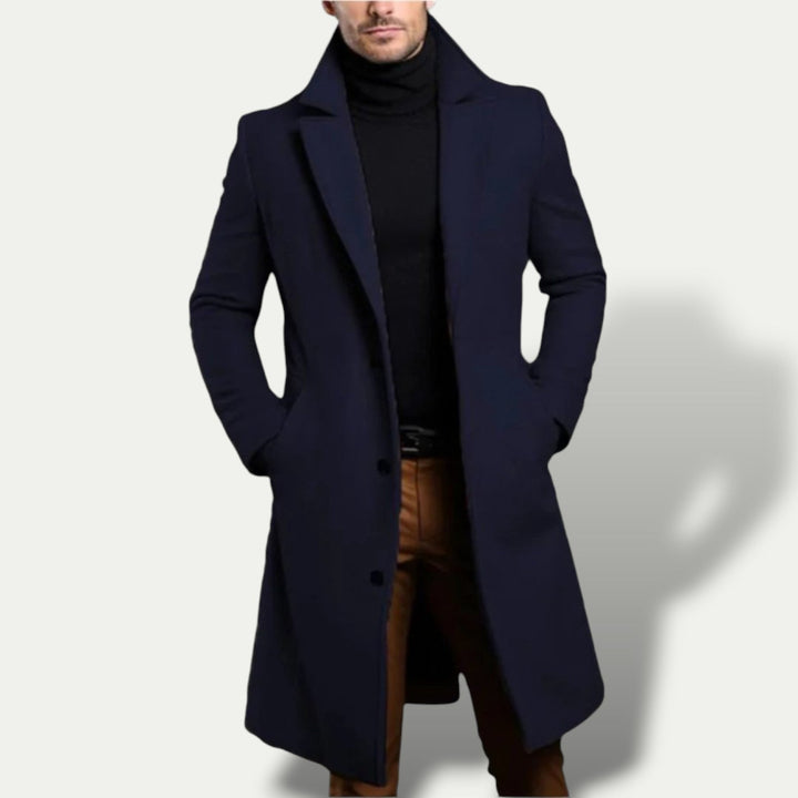 Stylish men's single breasted long coat in dark blue, perfect for smart casual or business wear. Classic tailored outerwear.