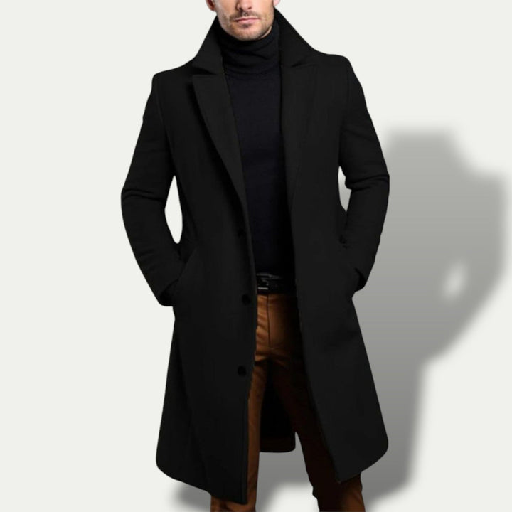 Dark gray men's long single breasted trench coat, versatile outerwear for smart casual or business occasions. All-season style.