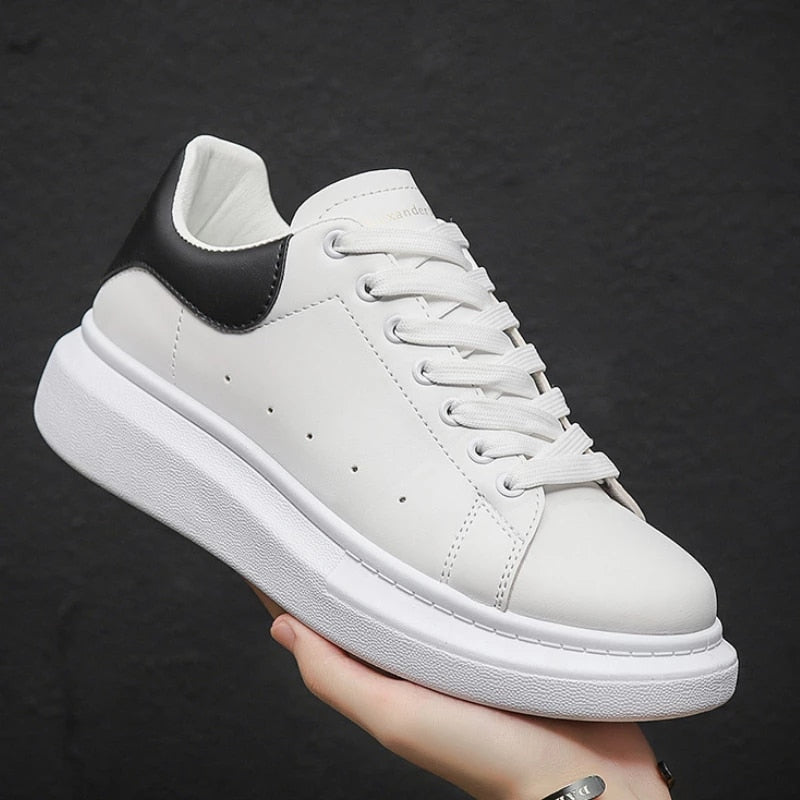 Pair of sleek men's urban sneakers, showcasing breathable material & comfortable design for stylish everyday wear.