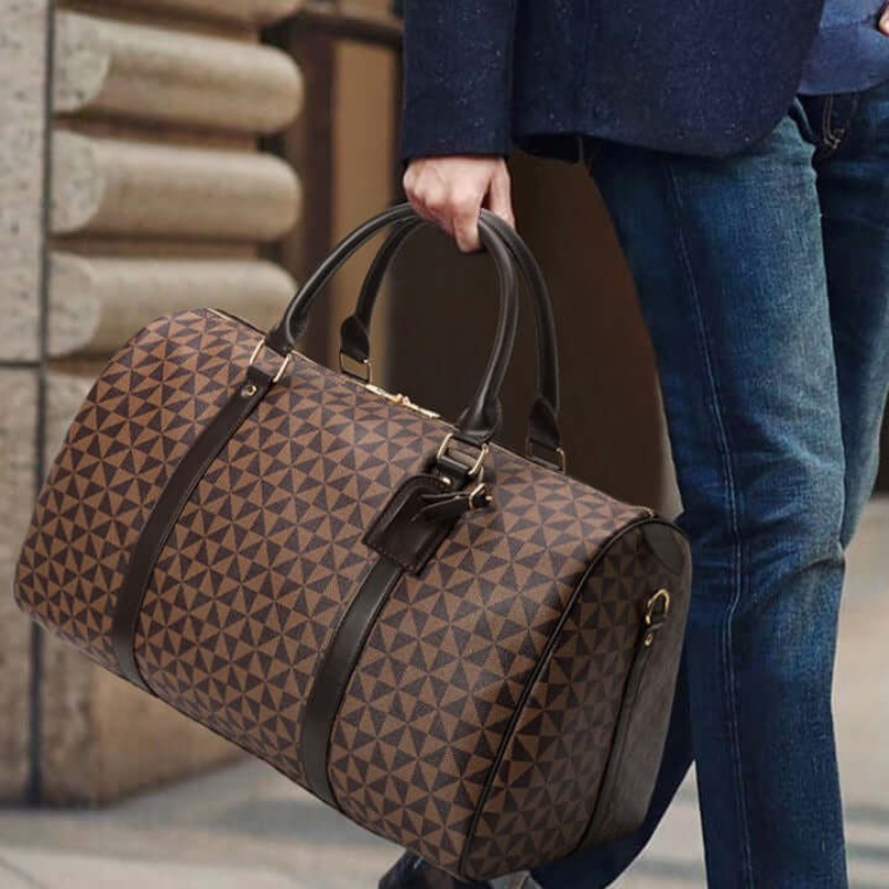 Sleek black unisex travel duffle bag, perfect carry-on luggage for business or casual weekend travel.