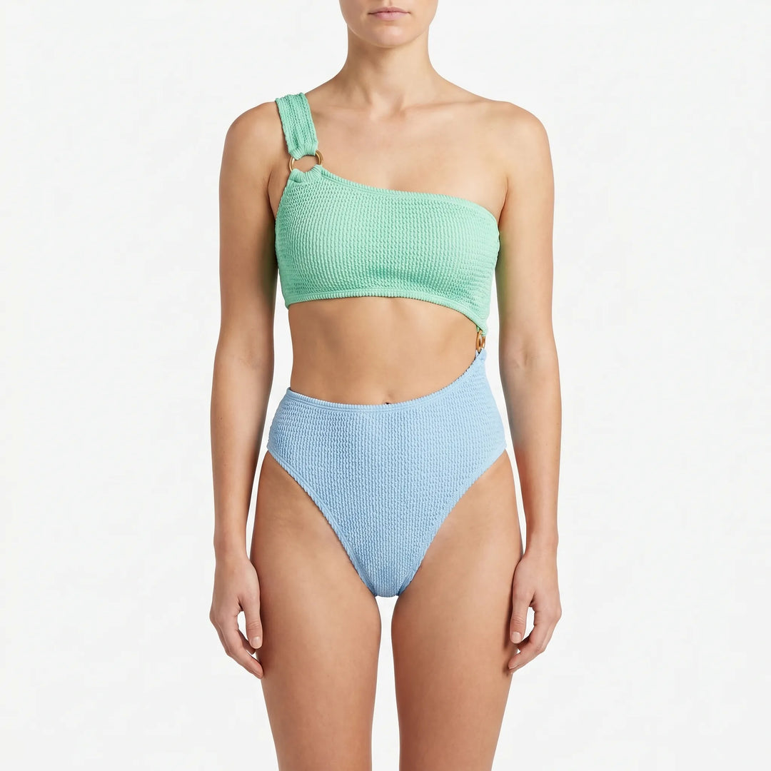 Asymmetric monokini swimsuit for women, featuring trendy cut-outs and gold-tone rings, a stylish one-piece swimwear.
