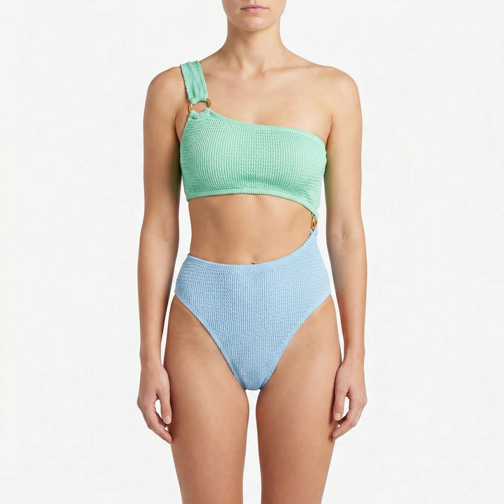 Asymmetric monokini swimsuit for women, featuring trendy cut-outs and gold-tone rings, a stylish one-piece swimwear.
