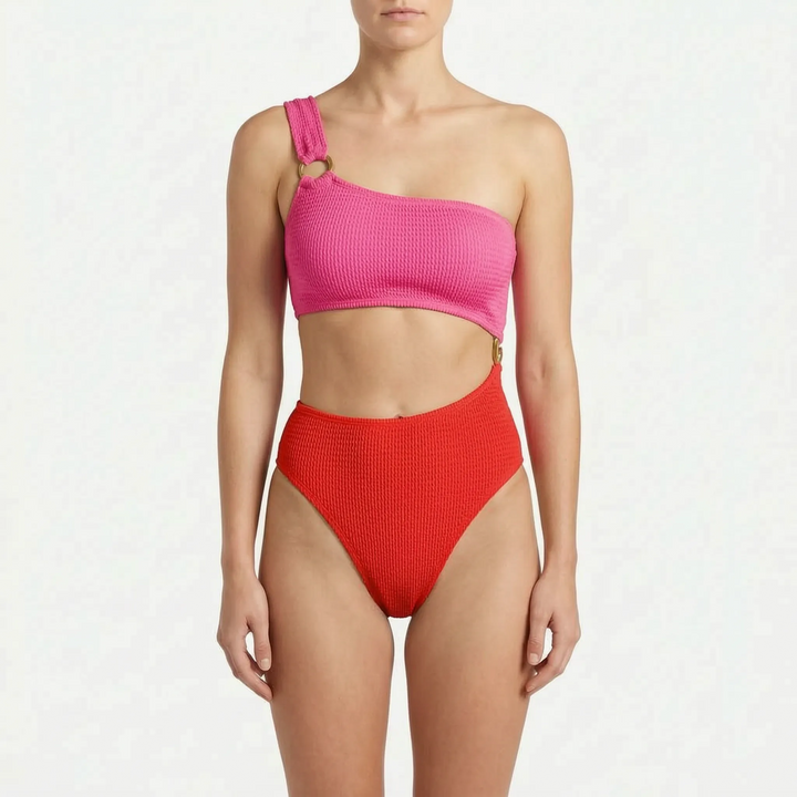 Glamorous women's asymmetric monokini with shimmering gold-tone rings & stylish cut-out detail for modern swimwear.