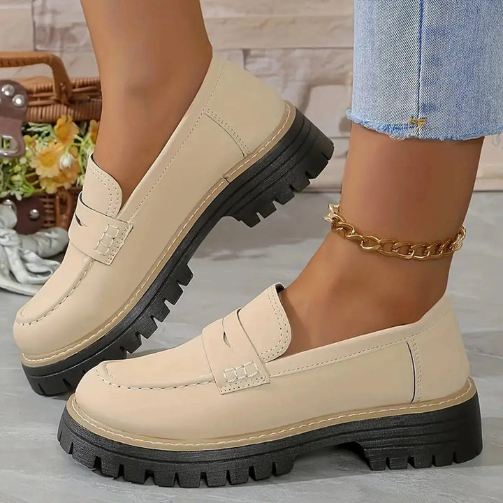 Stylish women's chunky platform loafers with a comfortable slip-on design, perfect for everyday casual or office wear.