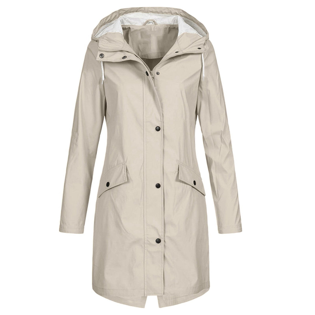 Woman wearing a fashionable hooded raincoat outdoors, protected from rain. Lightweight & waterproof outerwear.
