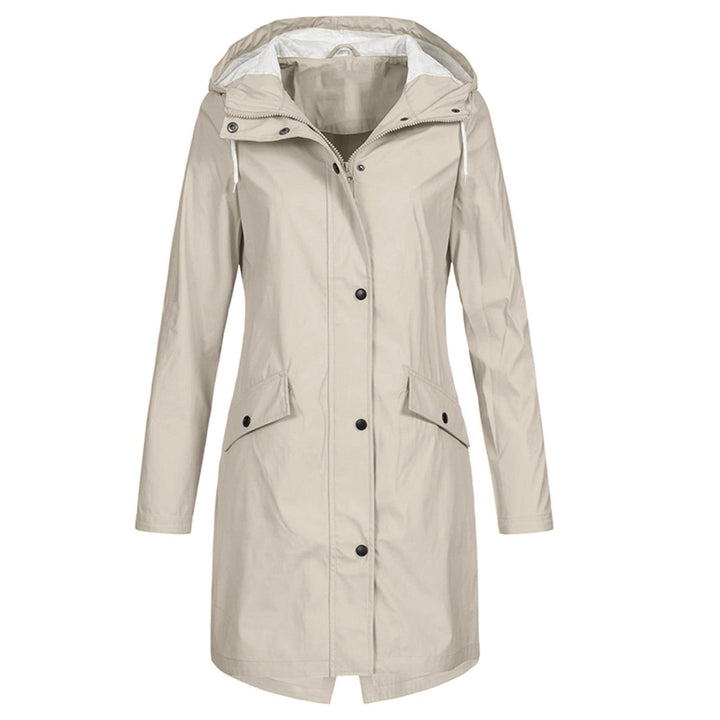 Woman wearing a fashionable hooded raincoat outdoors, protected from rain. Lightweight & waterproof outerwear.