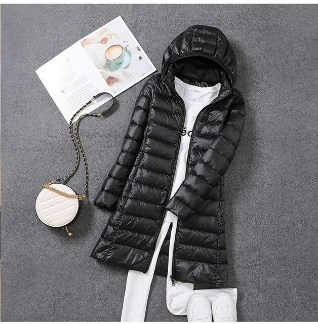 Warm insulated women's long winter coat with hood, perfect for cold weather, windproof and water resistant.