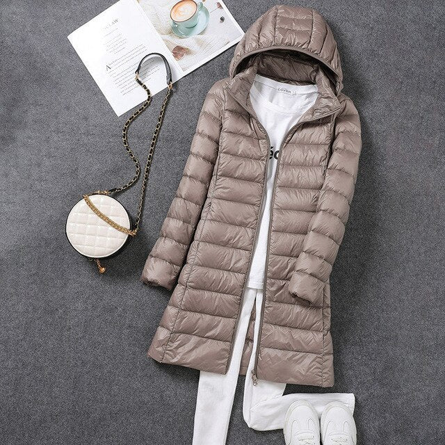 Comfortable women's long winter coat, featuring a cozy hood and insulated design for extreme cold weather.