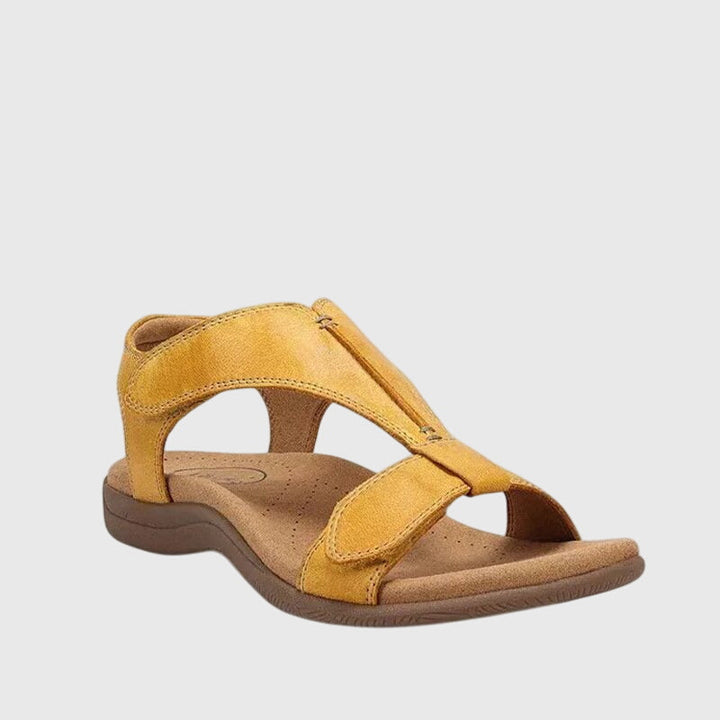 Woman wearing open-toe comfort sandals for walking, providing orthopedic support & all-day relief.