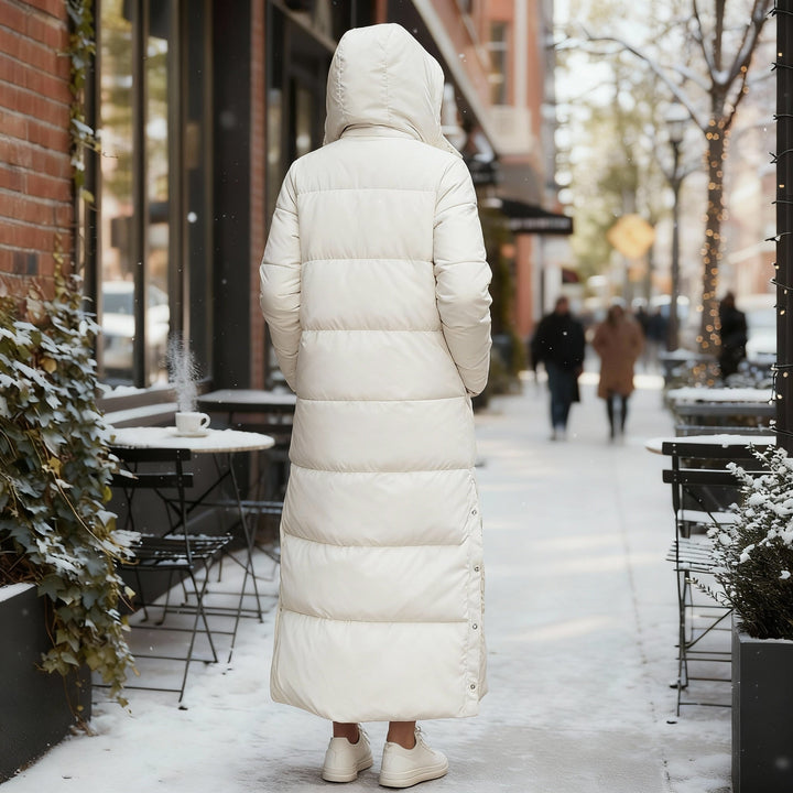 Warm hooded women's quilted winter jacket, long design for stylish fall & winter fashion outerwear.