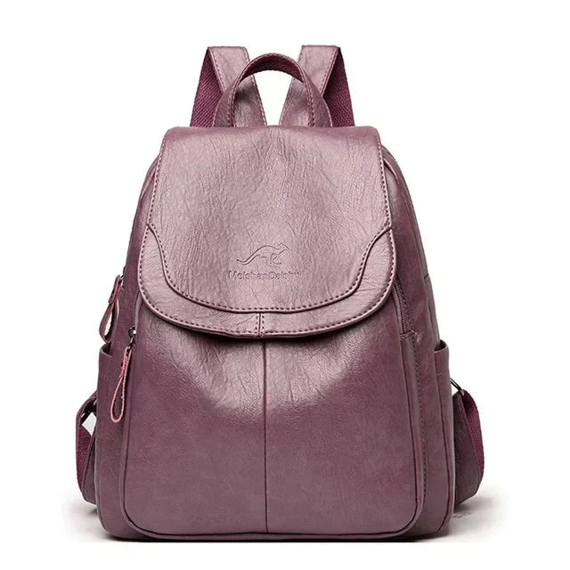 Elegant ladies' structured backpack with a secure flap closure, ideal for work, travel, and casual use.