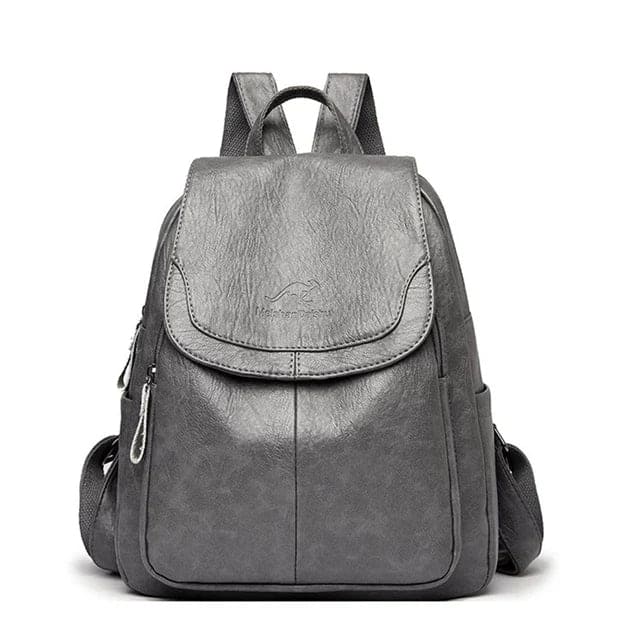 Solid color structured women's flap backpack, a chic and practical everyday carry bag.